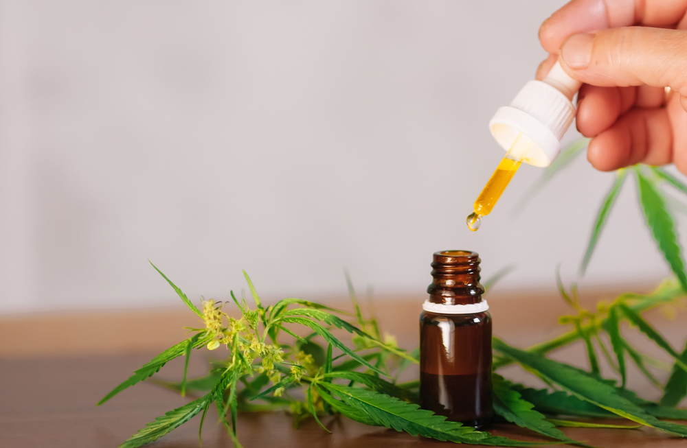 Pharmaceutical CBD oil tincture in a small bottle with a stopper - is CBD good for tooth pain?