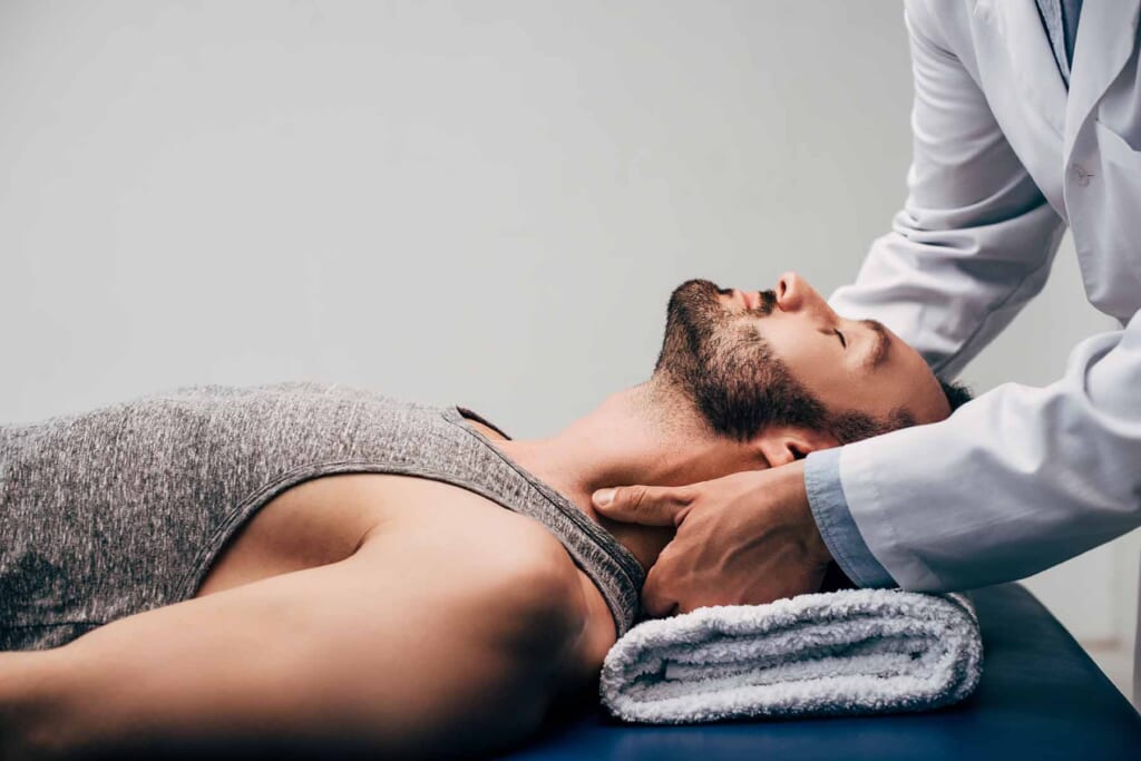 bigstock Chiropractor Massaging Neck Of 306021151